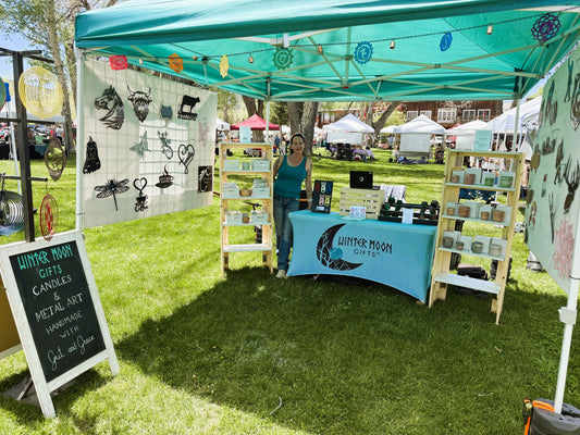 Winter Moon Gifts booth at the Ridgway Farmers Market with handmade goods on display